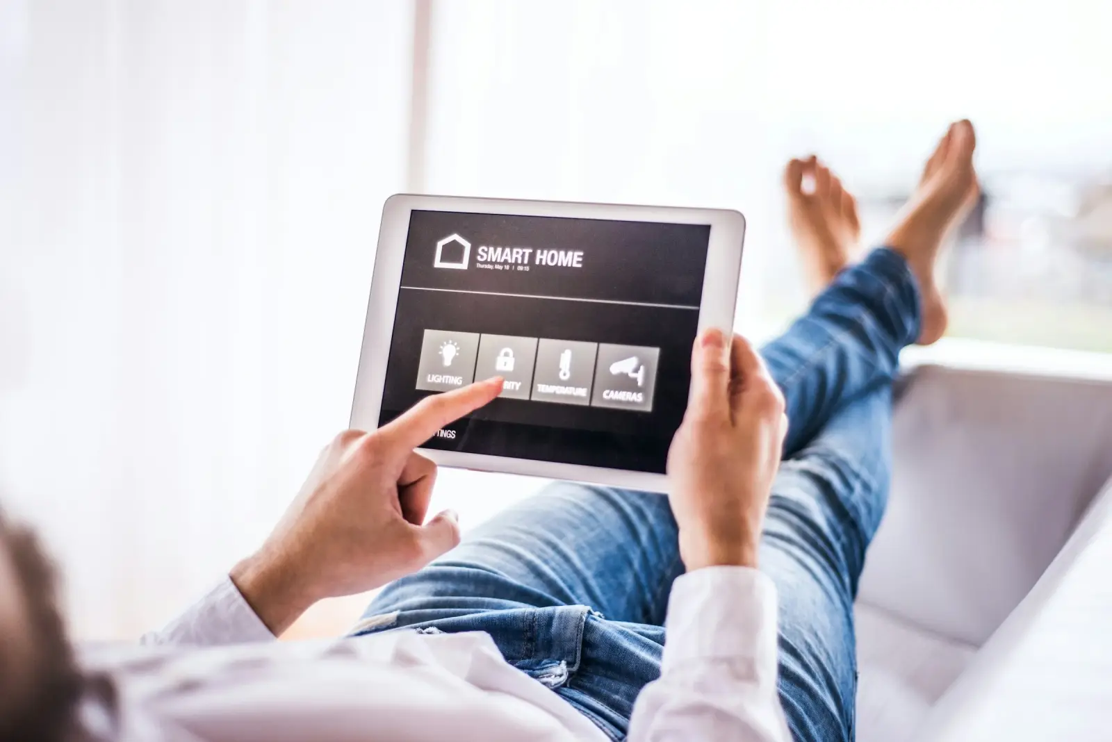 Person using smart home security on tablet